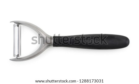 Vegetable peeler. Isolated on white background, top view, close up. Royalty-Free Stock Photo #1288173031