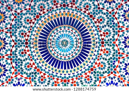The colorful and intricate geometric patterns of an Islamic mosaic decorate the walls of a kasbah in Morocco.