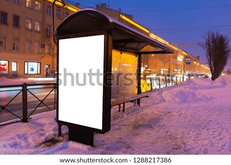 vertical poster. outdoor advertising in the evening. stand for advertising mockup at a public transport stop