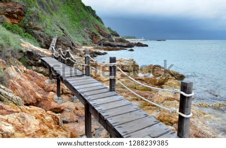 Wooden bridge at mountain side and the sea photo with outdoor cloud lighting