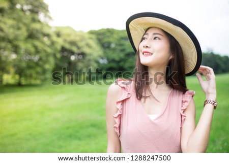 beautiful asian female wear vintage hat, she relax and smile on nature background, uv protection