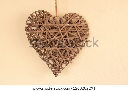 wooden love heart on a yellow background
