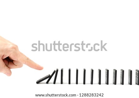 Finger, human hand drops the bones of dominoes on a white background. Royalty-Free Stock Photo #1288283242