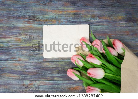 Pink tulips flowers on wooden background selective focus place for text
