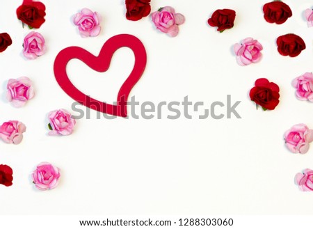 heart and roses lie on a white background