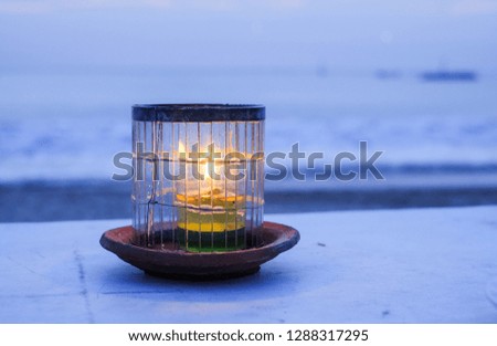 Candle on the background of the ocean, fire