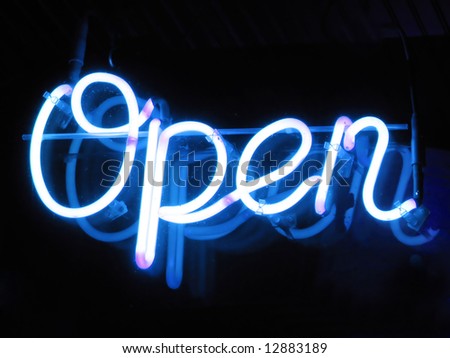 A neon "open" sign glowing blue in the window of a restaurant.