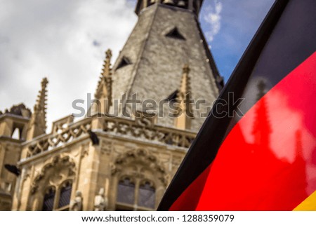 the German Flag Set against a Historic Building in Cologne, Germany