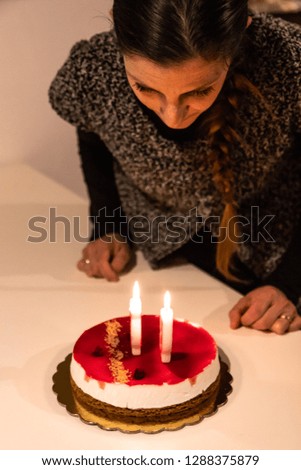 a young woman extinguishes the candles for her 39th birthday. A girl reaches the age of maturity.