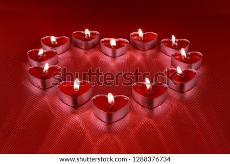 Valentine's Day, Heart shaped candles on red background
