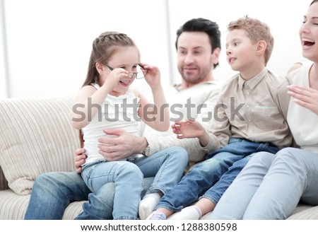 loving parents with children sitting on the couch
