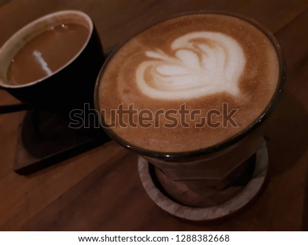 Close-up of Latte Art Heart. Selective focus. Wooden background.