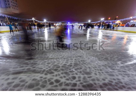 people ride on a night skating rink, long exposure