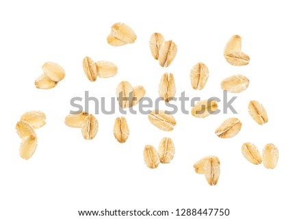 Dry raw oat flakes isolated on white background. Rolled flat grains of wheat, bran, barley, bye cereals for muesli or granola Royalty-Free Stock Photo #1288447750