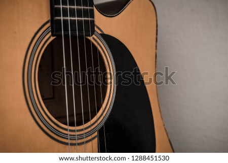Close up wooden 6 strings acoustic guitar.