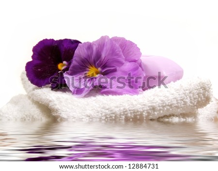 Spa items in lavender and purple with pansies with water reflection