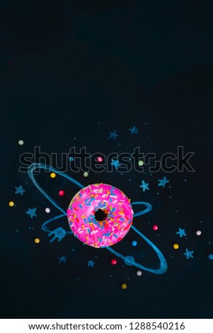 Space donut chalk drawing with orbits and stars. Flat lay food photography. Creative concept with copy space.