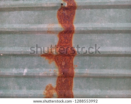 Rust on green metal sheet roof texture background.