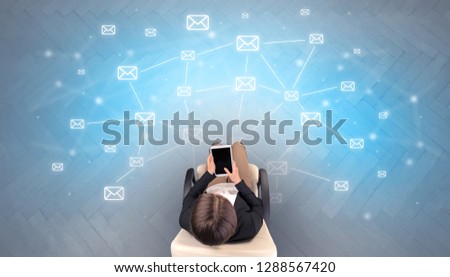 Mail symbols with woman using device in a beige chair
