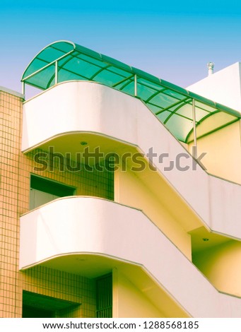 Low angle view of building with outside concrete staircase covered by green awning. Photo taken in Daejeon, South Korea.