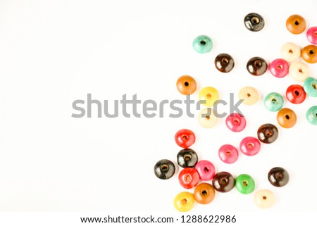 Variety colors of wood buttons on white background, idea hobby.