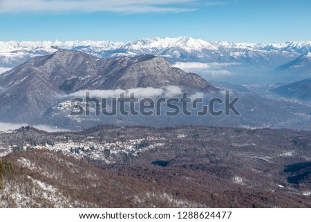 Italy. Campo dei Fiori Regional Park in the foreground, with Castello Cabiaglio village, in the background the Alpine chain. The town of Luino on lake Maggiore and Valcuvia are also visible