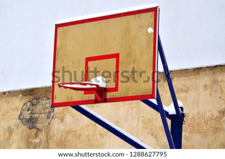 Basket for basketball in the city, street basketball hoop in winter, abandoned sport court