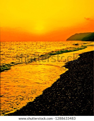 A mixture of orange and yellow sky envelopes a setting sun that turns Mediterranean waves into a sea of gold. Photographed off the coast of northern Italy near Deiva Marina.