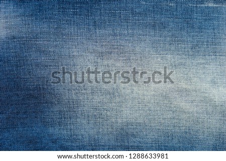 Faded blue jeans texture background