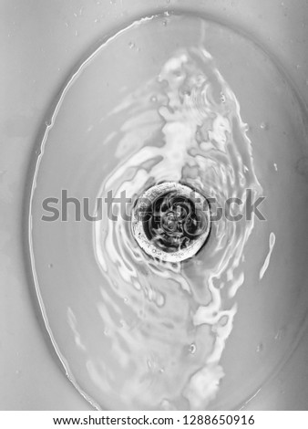 Black and white picture of Tap water in wash basin