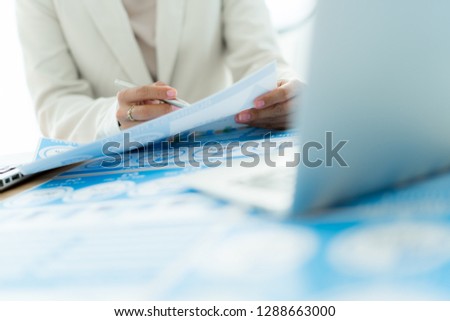 Business women reviewing data in financial charts and graphs. Accounting