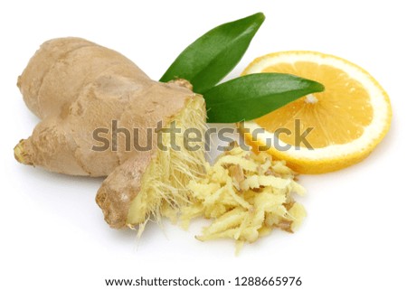 Fresh ginger root with leaves and lemon isolated on white background