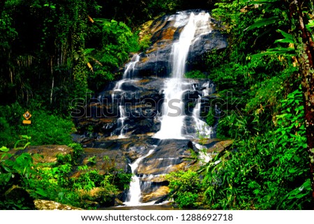 Landscape of waterfall in deep rain forest .