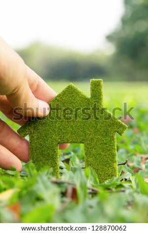 Hand holding eco house icon concept