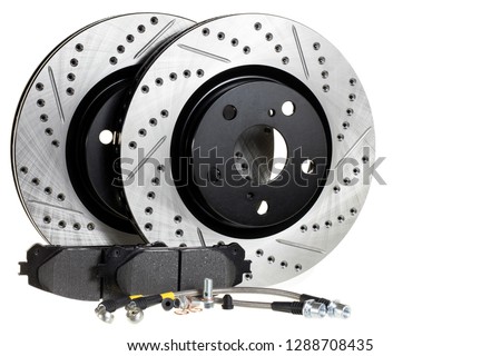 Tuning the brake system of the car. Perforated brake discs, ceramic pads and reinforced hoses - all for better braking.brake disc, pad and reinforced brake hose on a white background Royalty-Free Stock Photo #1288708435
