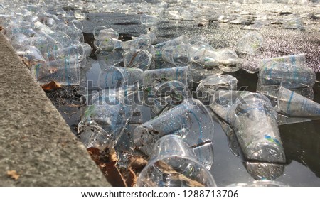 Empty Plastic Cups littering the street during a marathon - Close up / Detail Royalty-Free Stock Photo #1288713706