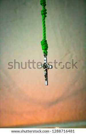 Vertical image of Rosary Illuminated by a Candle