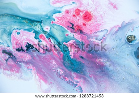 Abstract colorful background. Drawing with acrylic paints on water. Texture play of paint.