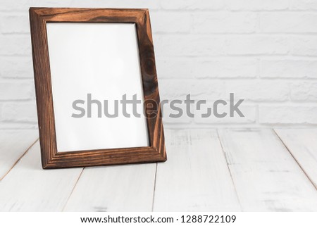 Photo frame on white wood table with copy sapce.