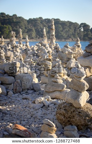 Stone pyramids on the beach of golden cape rovinj, croatia
