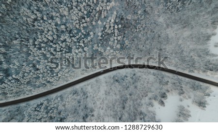 Aerial view of winter road in snowy forest