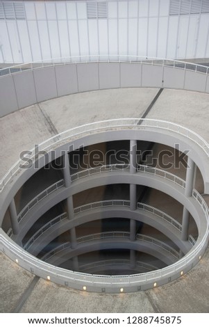 architectural construction of underground grage with spiral staircase