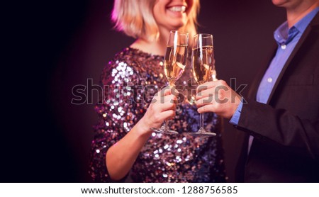Image of happy couple with champagne glasses with champagne on black background