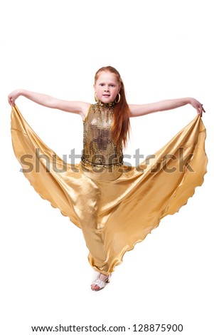 dancing happy little redhead girl in golden dress, isolated on white