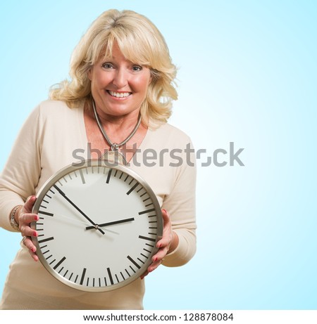 Happy Woman Holding Clock against a blue background