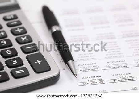 Showing business and financial with calculator and pen on book