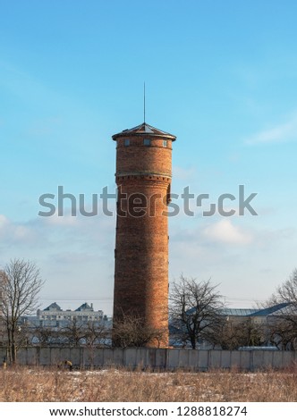 Landscape with an old water tower, which is located in the picturesque corner of the European country.