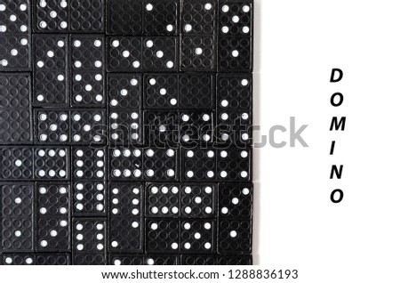 Black dominoes on white background with copy space