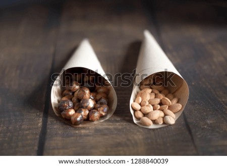 almonds and hazelnuts  on wood background 