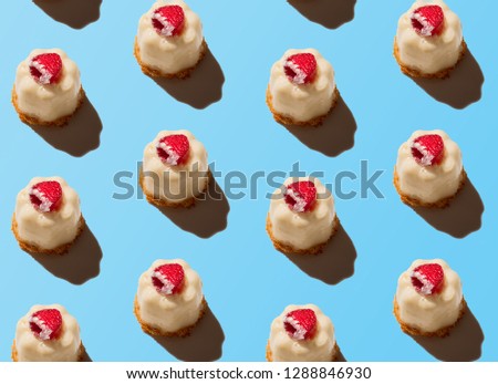 Creative art picture cake with raspberries on a blue background. Isometric flat lay 